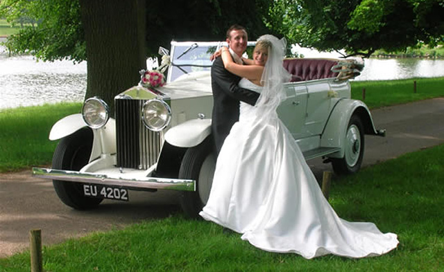 Rolls Royce Tourer with bride and groom